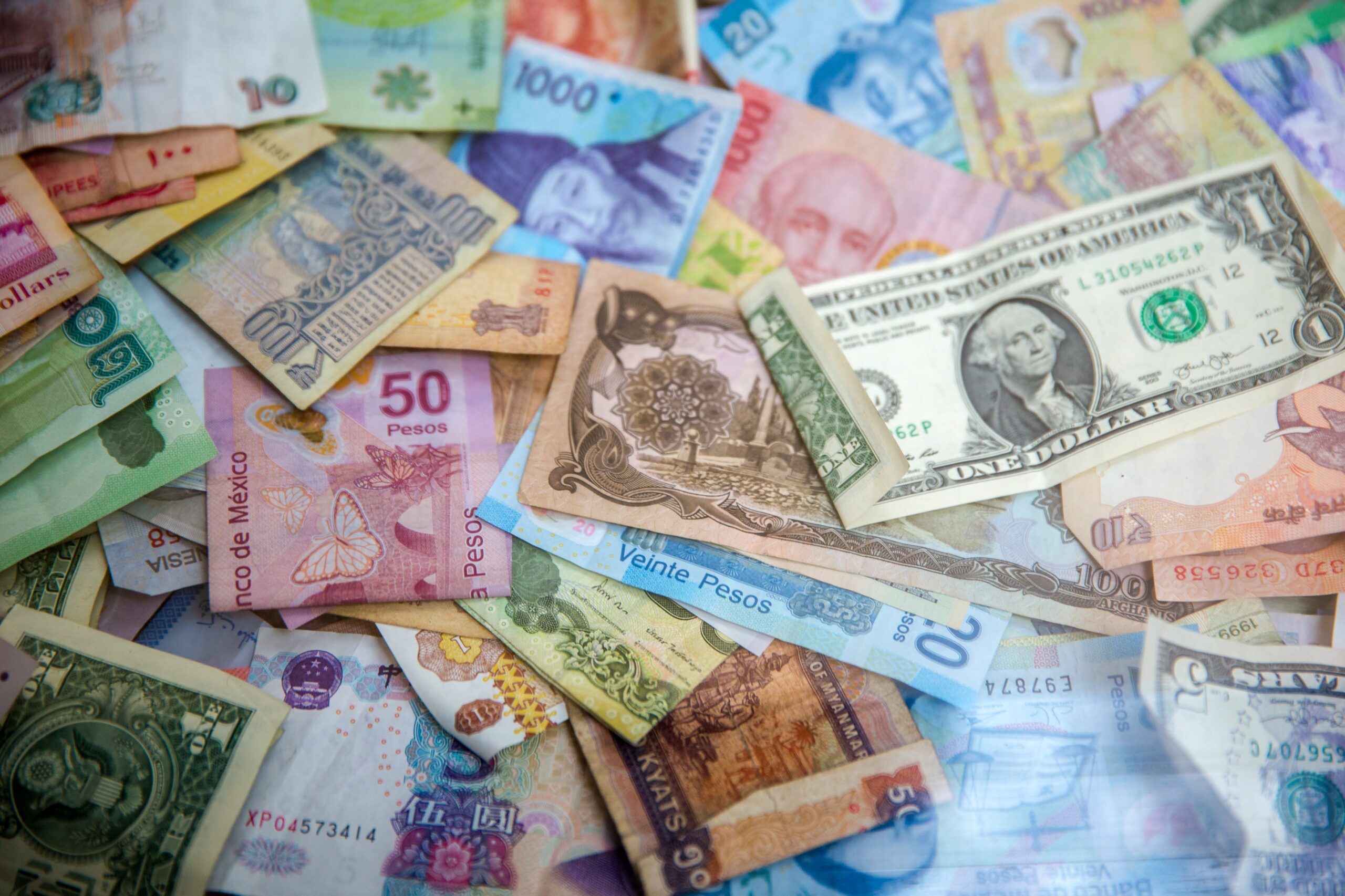 Pile of dollar bills from various countries